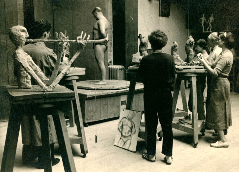 Sculpture life room c. 1955, right to left- Reid Moffat,  sculpture of trumpet player by Alan Fletcher  - Sheila McLaughlin back to us, Eleanor Christie (furthest away), Benno Schotz and Janie Alston.
Big Jimmy, the model.